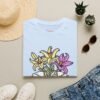 Book and Flowers T-Shirt - Yellow and Purple Lilies Design, Literary Botanical Art Tee, Unisex Gift for Readers and Nature Lovers