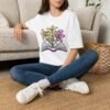 Book and Flowers T-Shirt - Yellow and Purple Lilies Design, Literary Botanical Art Tee, Unisex Gift for Readers and Nature Lovers