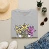 Book and Flowers T-Shirt - Yellow and Purple Lilies Design, Literary Botanical Art Tee, Unisex Gift for Readers and Nature Lovers
